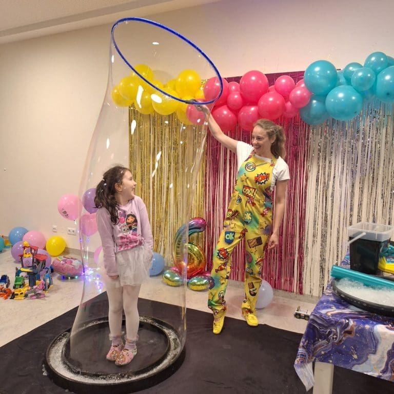 A kid inside a giant bubble in the bubble show in Vienna