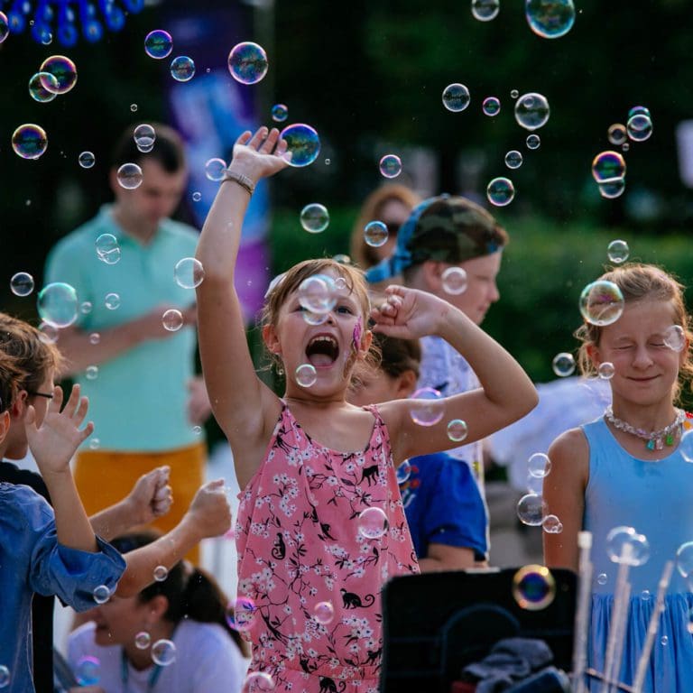 Kids Laughing While Playing with Bubbles